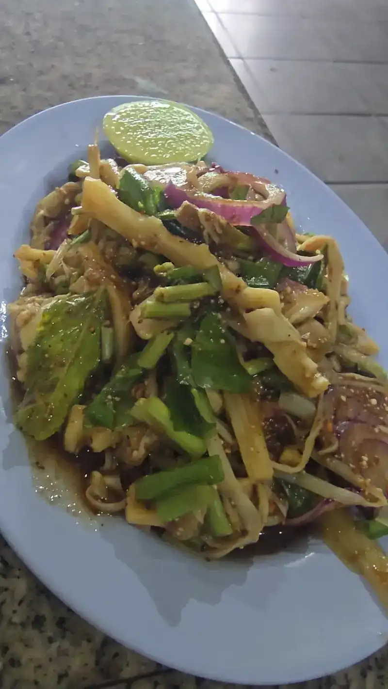 Shredded bamboo-shoot salad with herbs, shallots and a slice of lime
