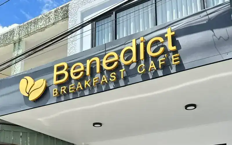 The cafe's charcoal front with gold letters reading Benedict Breakfast Cafe