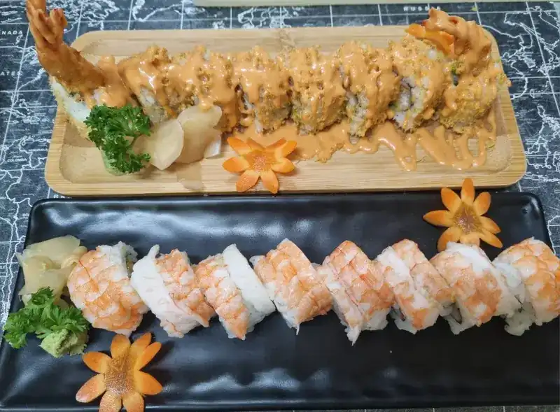 Tempura roll with sauce and a shrimp roll on long plates