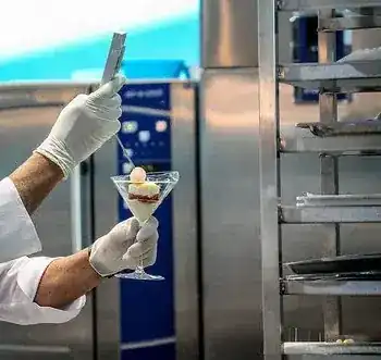 Gloved hands finishing a gelato dessert in a glass