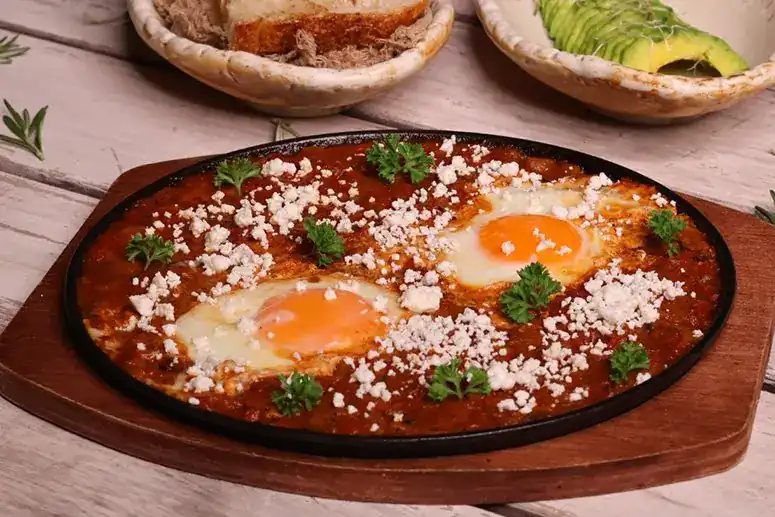 Shakshuka with two eggs in a cast-iron pan
