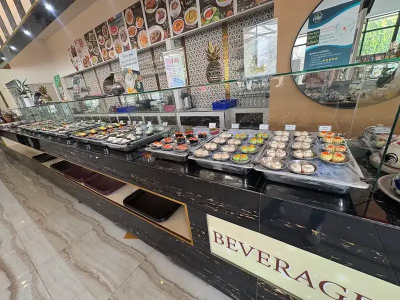 The long glass counter inside, lined with plates of dim sum