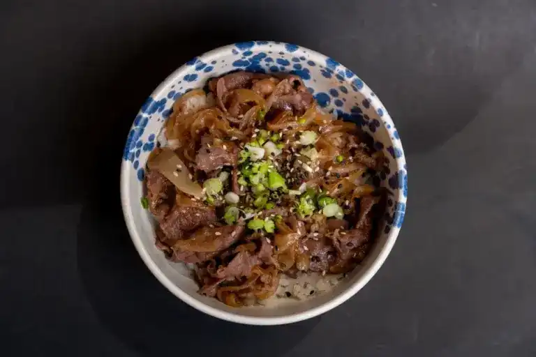 Beef sukiyaki rice bowl with spring onion