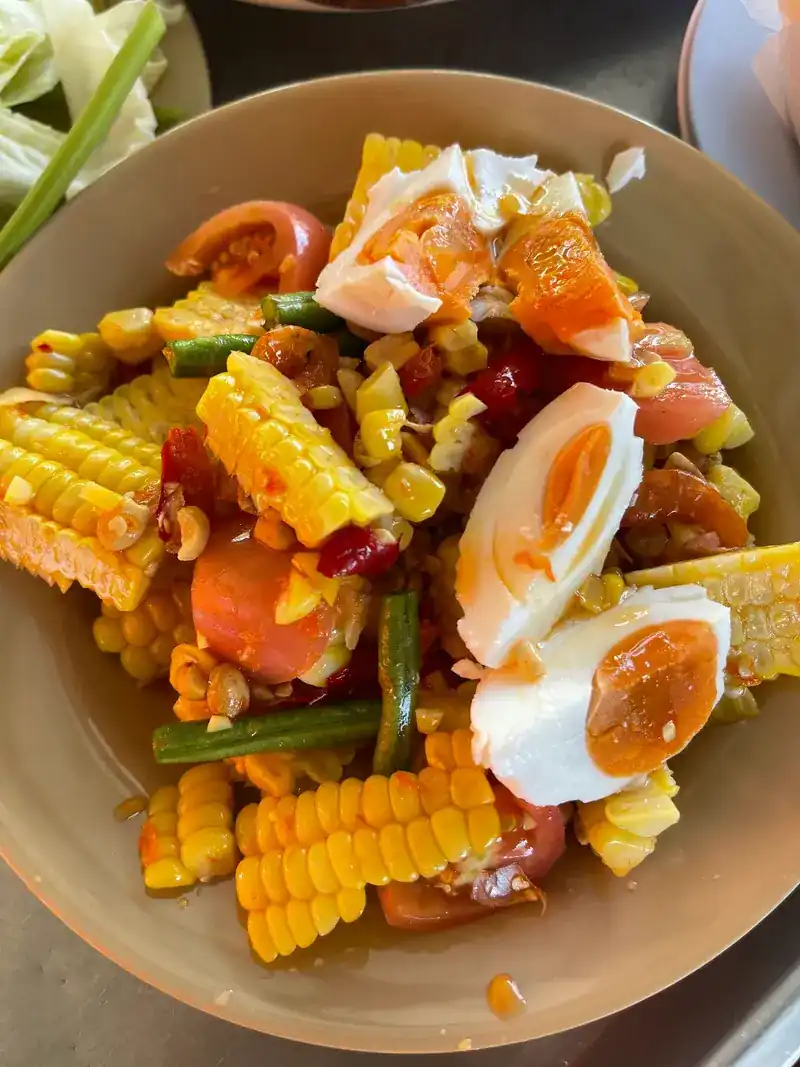 Corn som tam with halves of salted egg