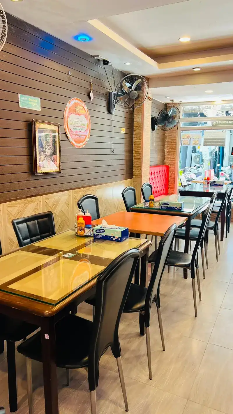 Tables along the slat wall, looking out to the street