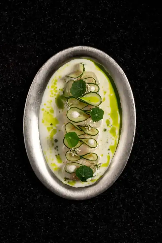 Hokkaido scallop with cucumber ribbons in coconut on a silver dish