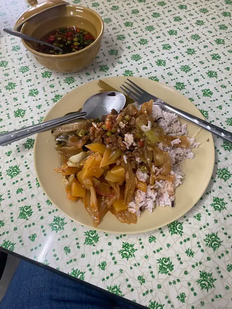 Rice with stir-fried vegetables, and a small bowl of chilli sauce