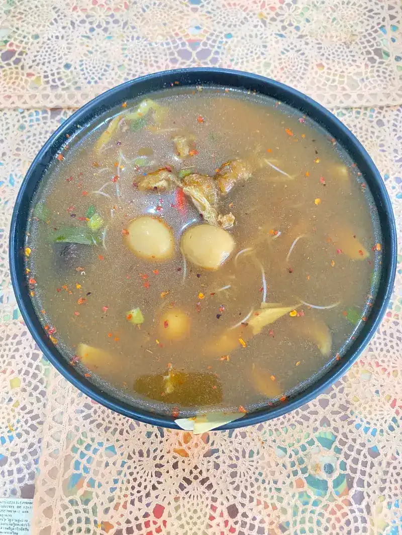 A bowl of hot and sour soup with mushrooms and chilli