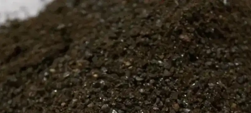 A heap of dark ground coffee, close up