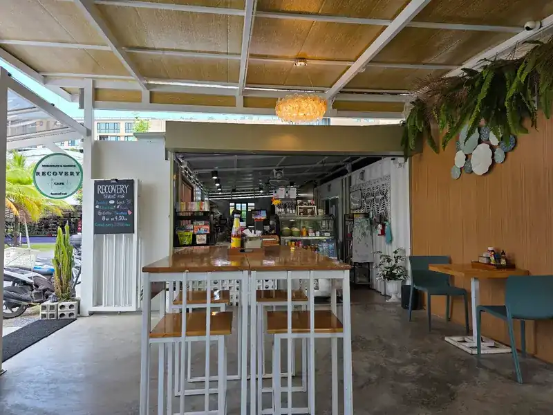 The counter and a long wooden table with high stools