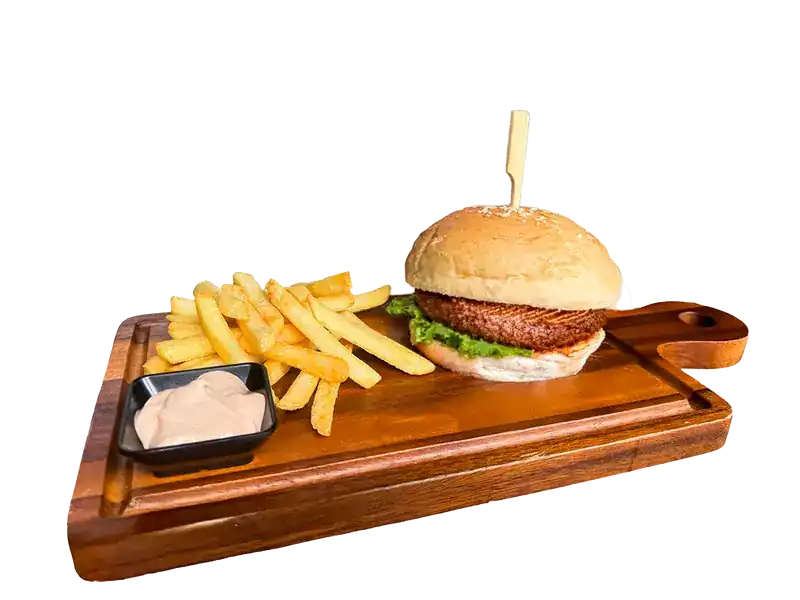 Hamburger with fries on a wooden board