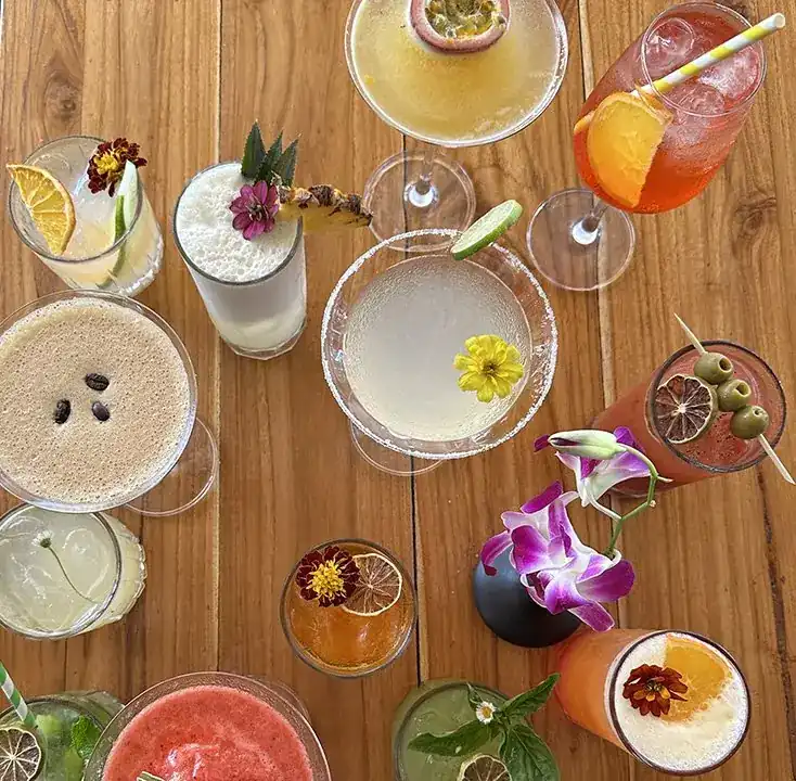 Signature cocktails on a wooden table, seen from above