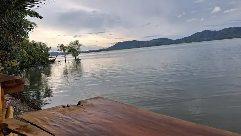 The bay seen from the wooden deck, with hills along the far shore