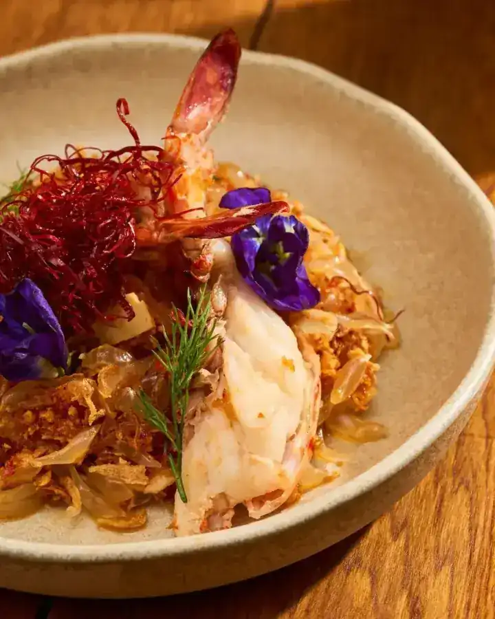Soft-shell crab in green peppercorn sauce with butterfly pea flowers