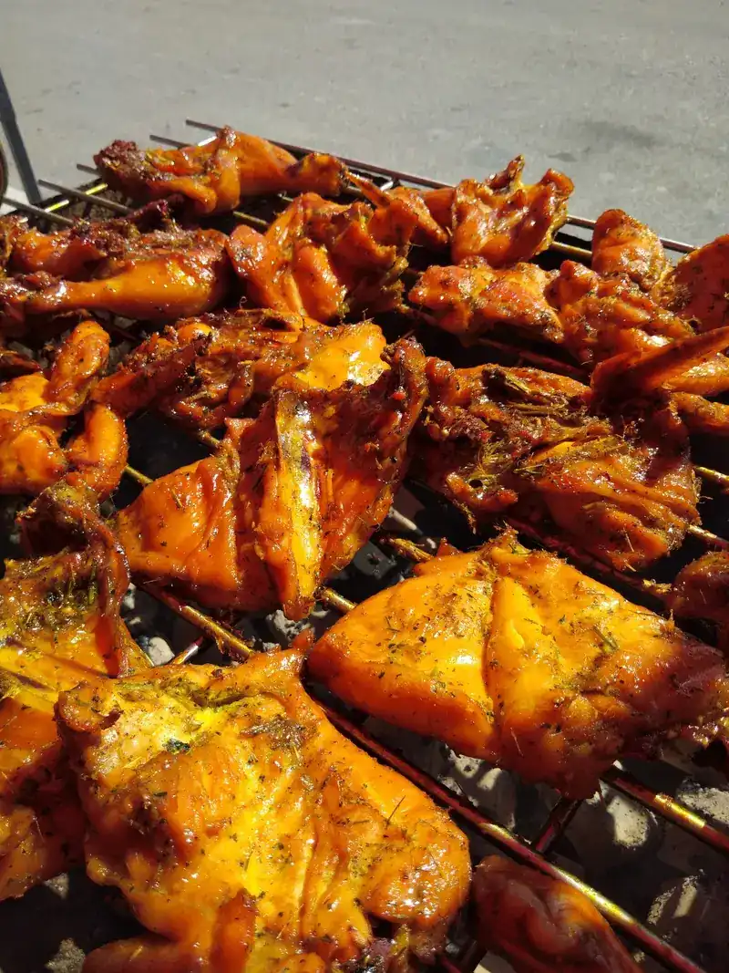 Chicken pieces browning on the charcoal grill