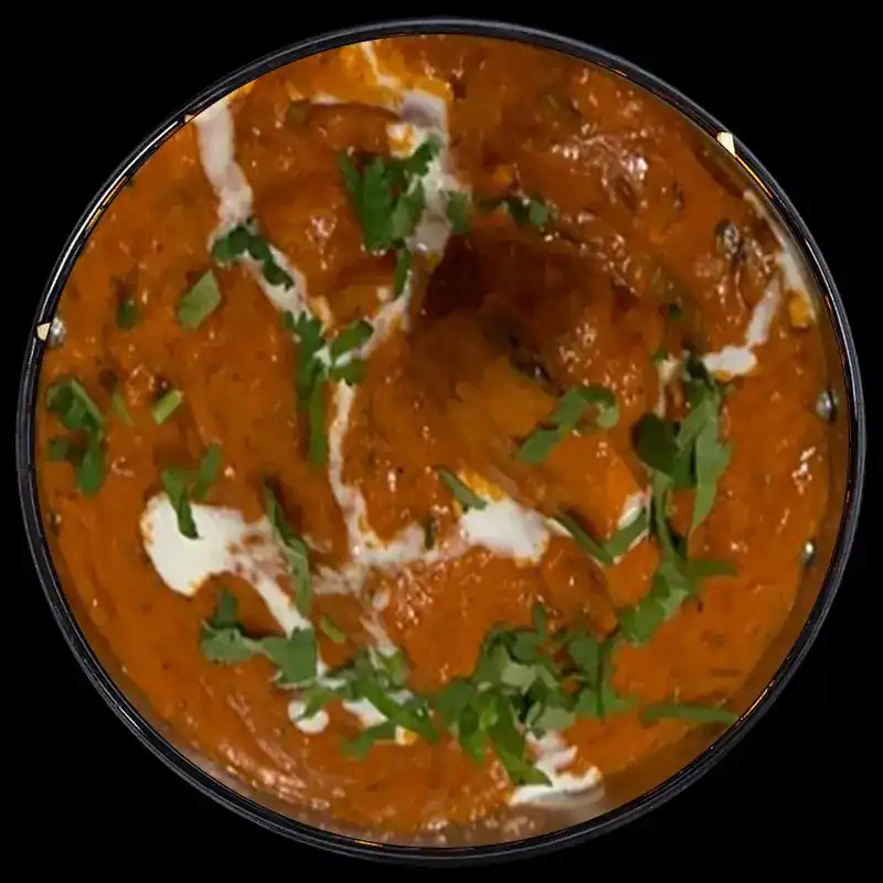 A bowl of red curry finished with cream and coriander