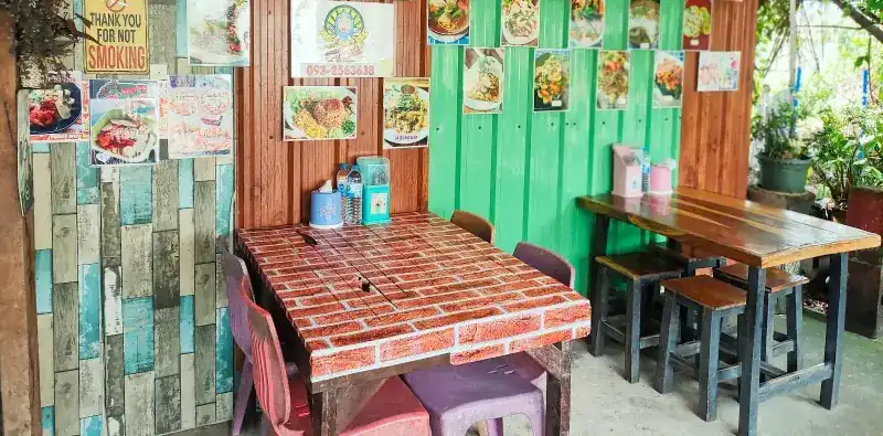 Inside the shop: brick-print tables, plank-pattern walls and dish photos on the wall