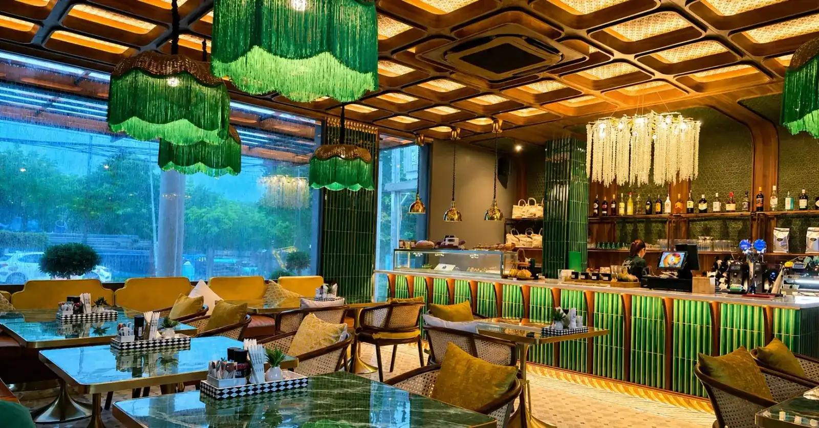 The café: green tiled bar, fringed green lamps and garden windows