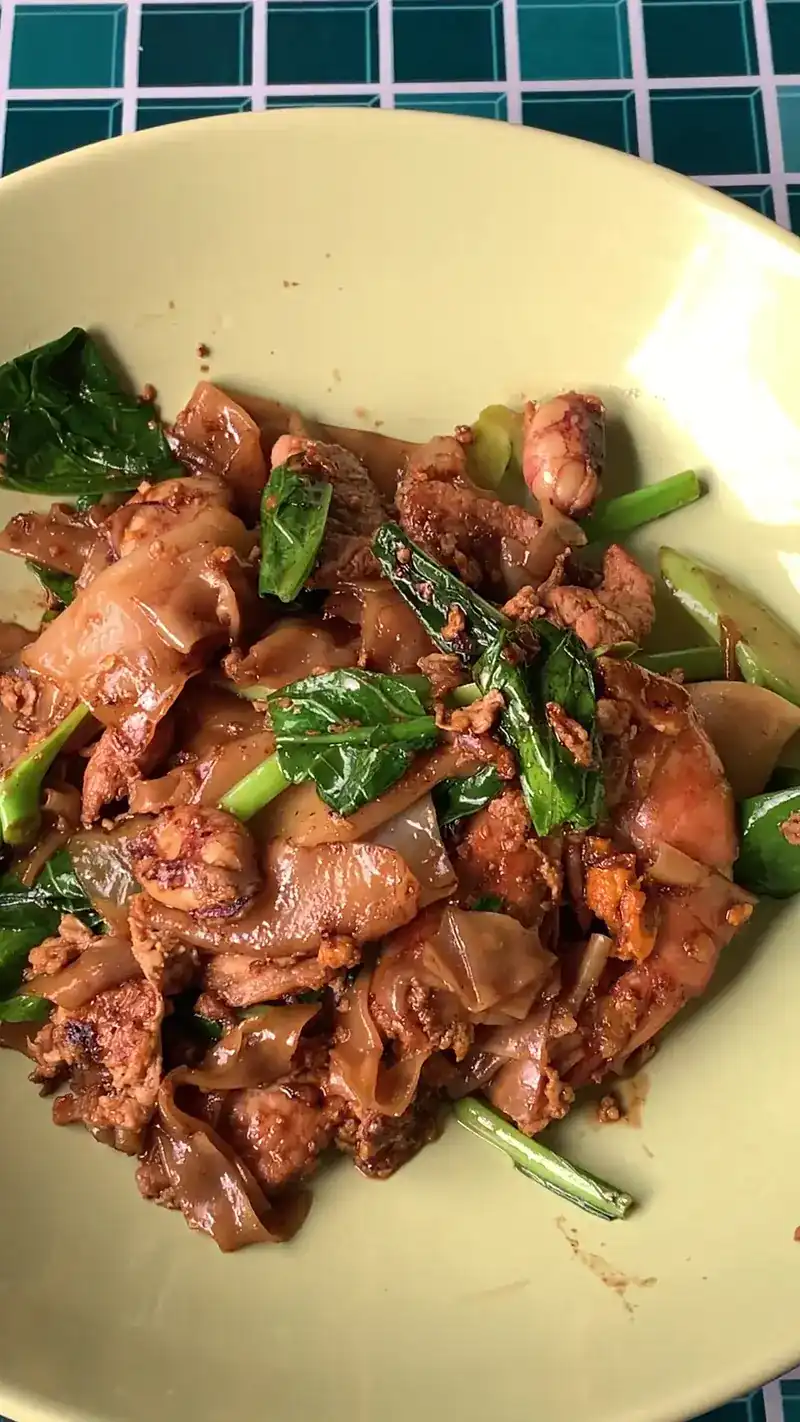 Wide rice noodles stir-fried in dark soy with Chinese kale