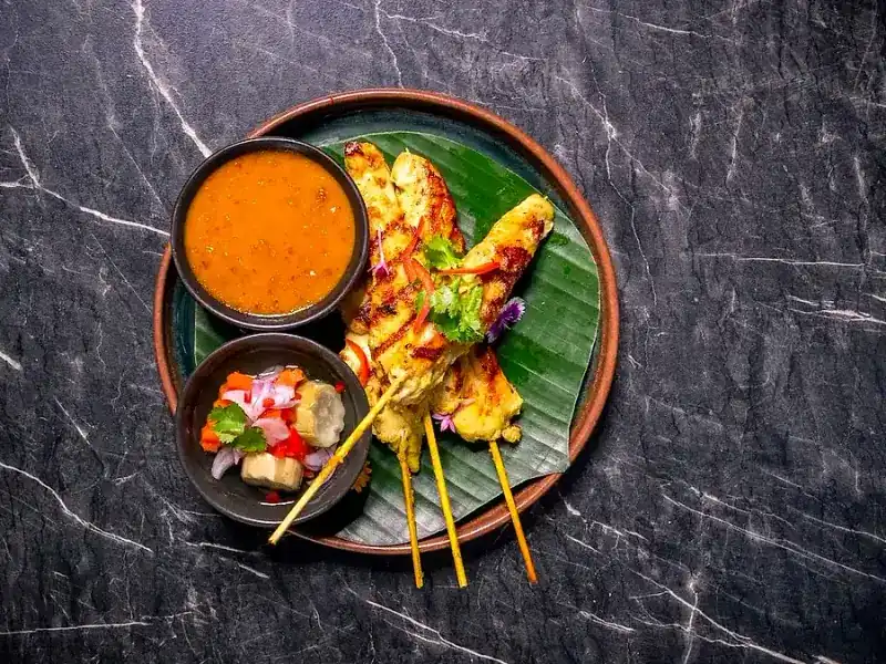 Chicken satay skewers with peanut sauce and cucumber relish