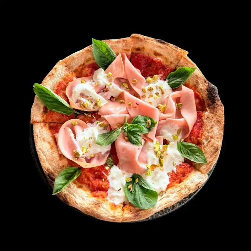A thin-crust pizza with basil leaves seen from above