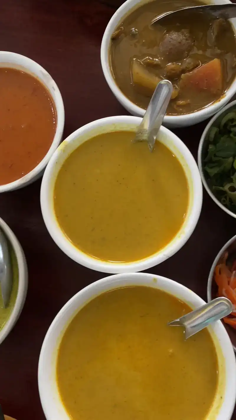 Bowls of different curries side by side