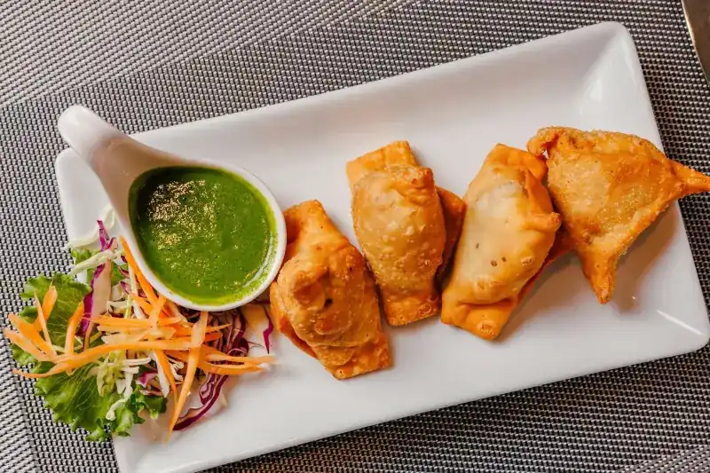 Samosas with green chutney and salad