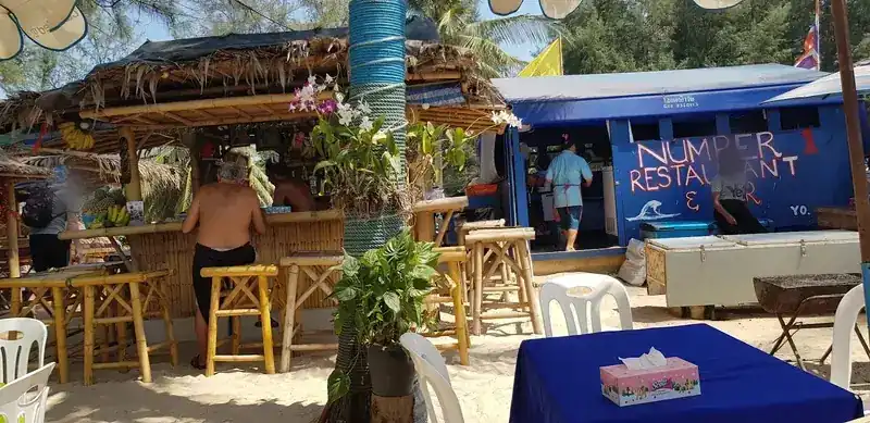 The bamboo bar and the blue kitchen booth with the Number 1 sign / บาร์ไม้ไผ่และซุ้มครัวสีน้ำเงินที่มีป้าย Number 1