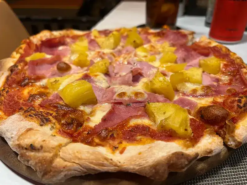 Ham and pineapple pizza with a blistered crust