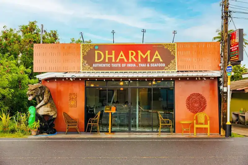 The orange front of Dharma Indian Restaurant in Bangtao with its gold-lettered sign