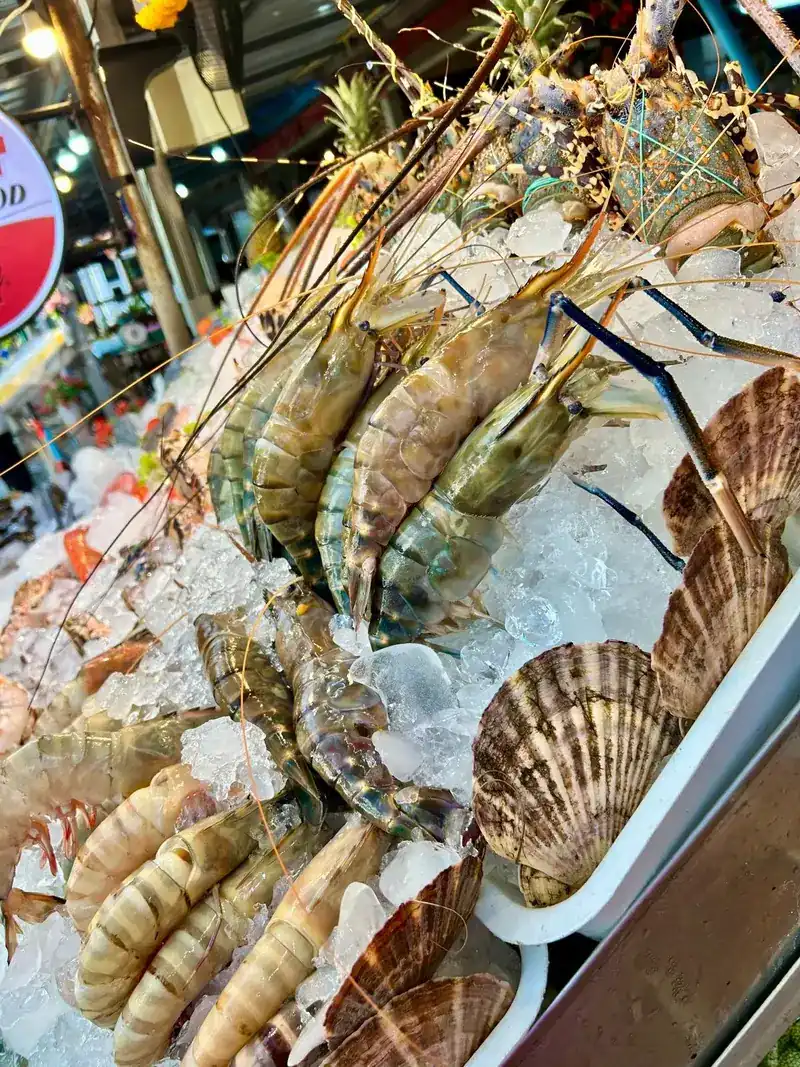 Tiger prawns, lobsters and scallops on ice