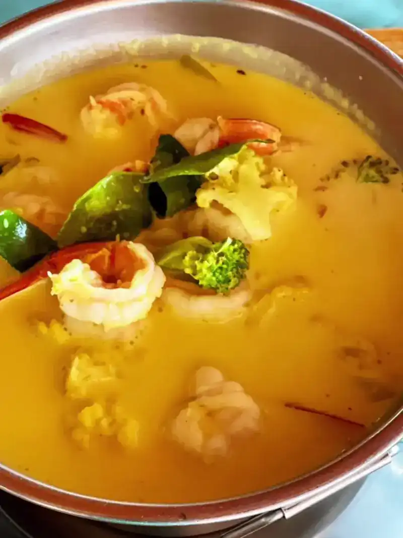 Creamy prawn soup with vegetables in a steel pot