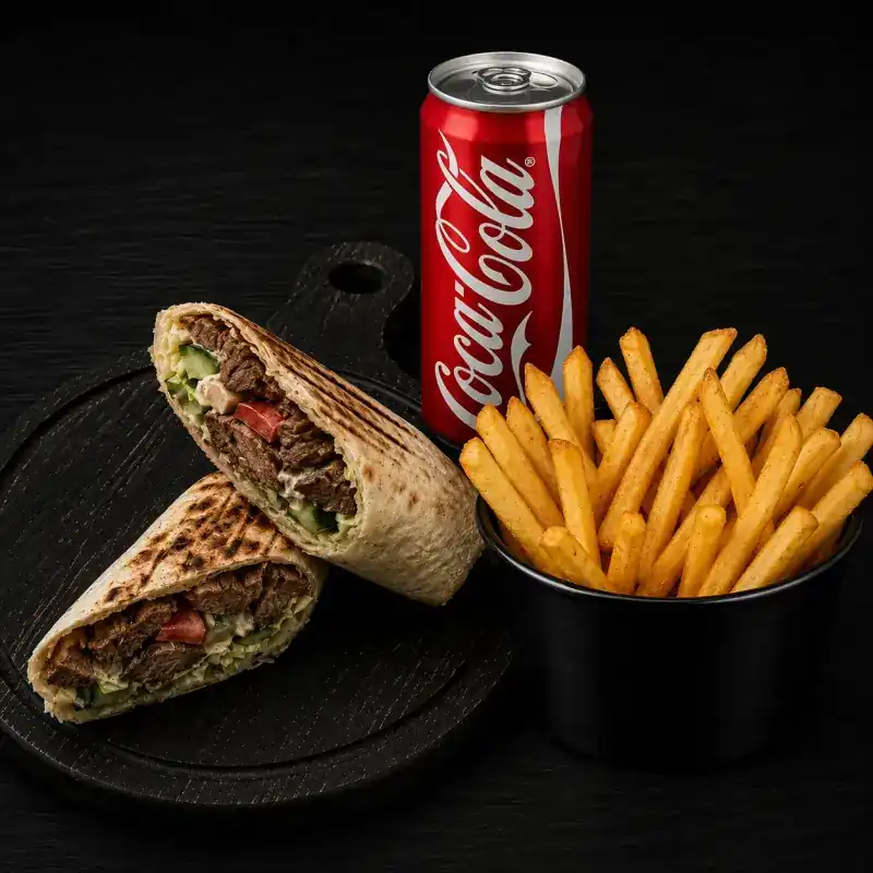Lavash wrap cut in two, grilled meat and vegetables showing inside