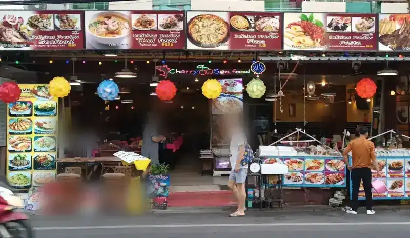 The front of Cherry Seafood on Patak Road, with paper lanterns, picture signs and seafood laid out on ice