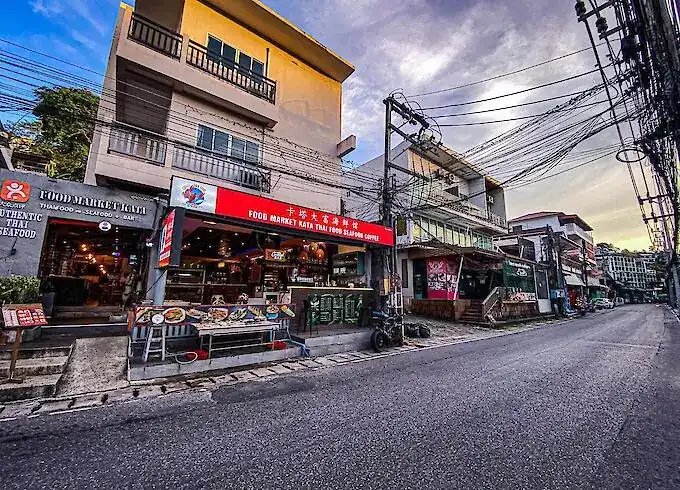 The restaurant front with its red sign on Koktanot Road, seafood displayed on ice by the pavement