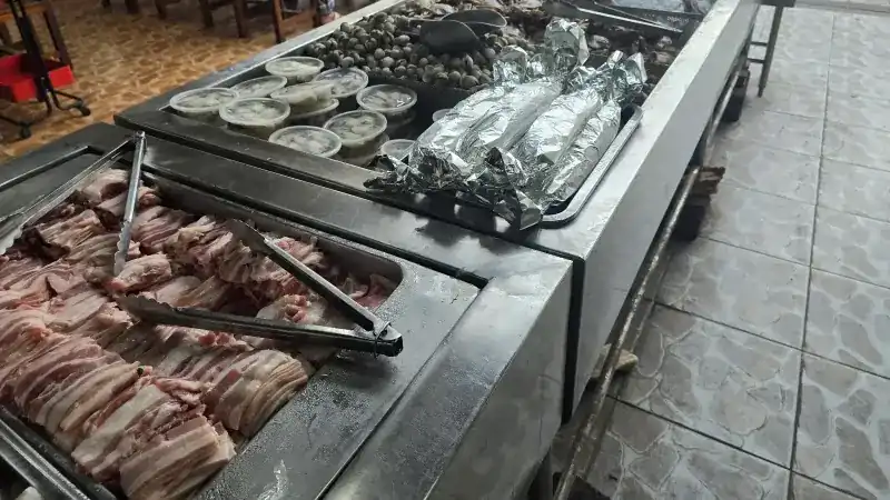 Pork belly, shellfish and foil parcels at the buffet counter