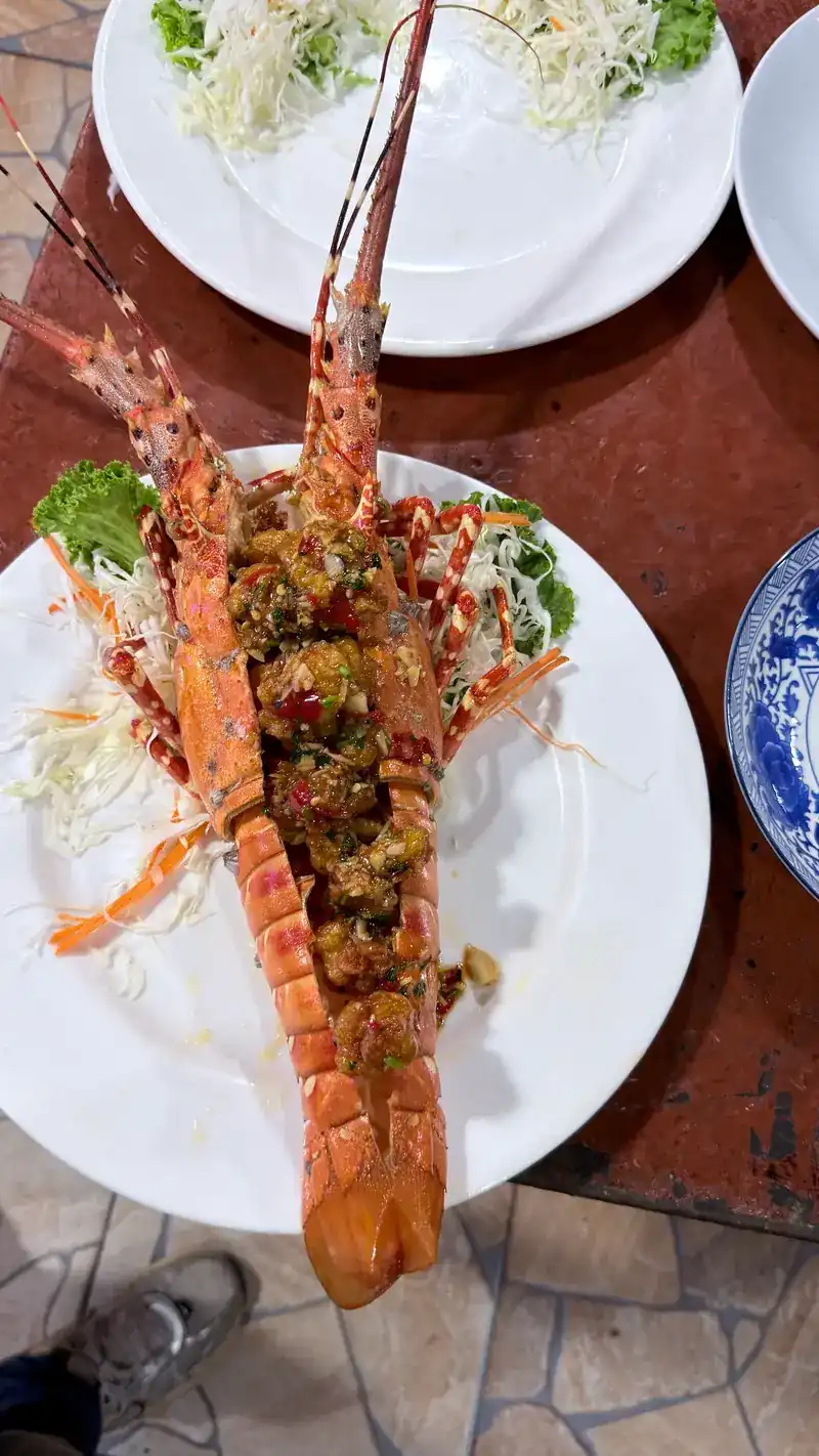 A split lobster under a chilli topping on shredded cabbage
