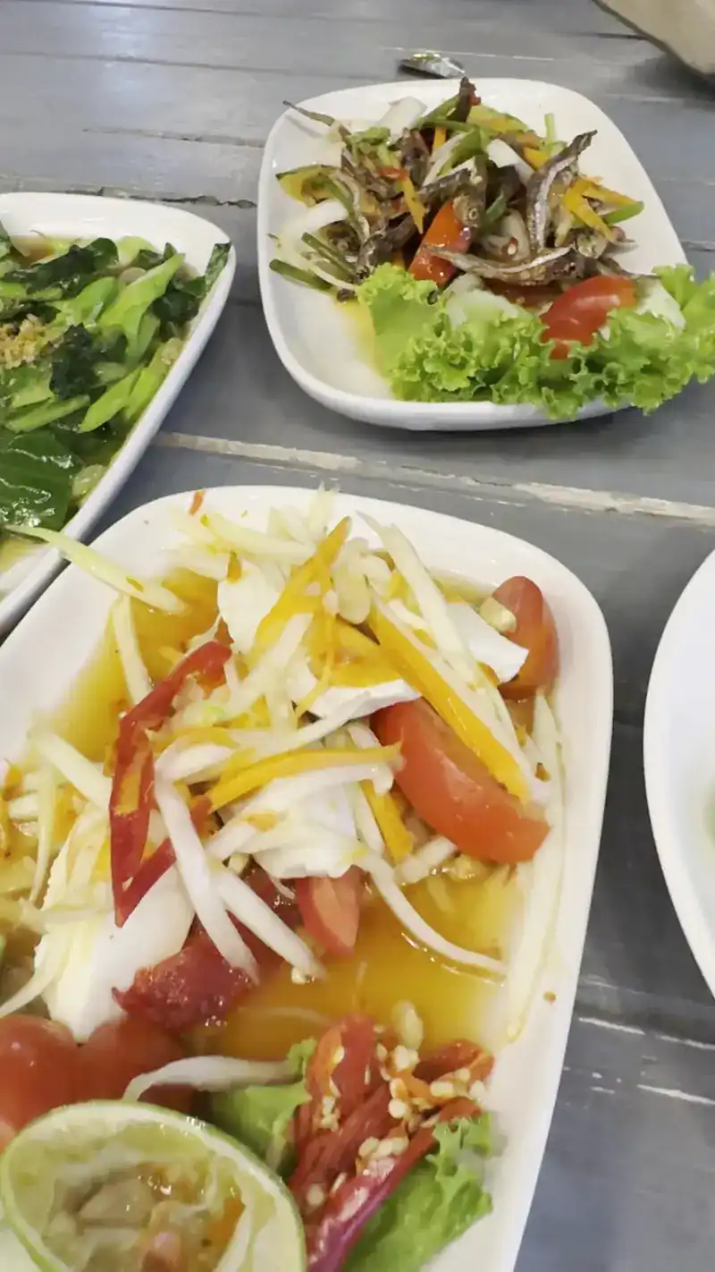 Papaya salad, crispy little fried fish and stir-fried greens