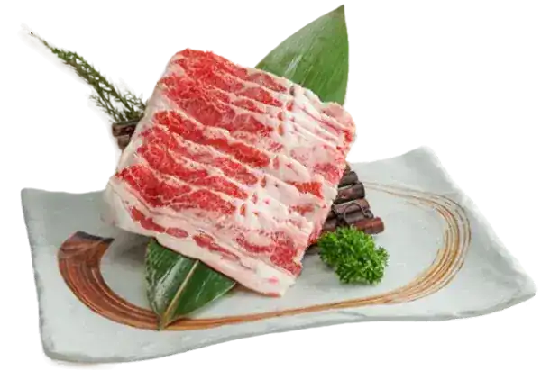 Thin slices of marbled beef on a bamboo leaf
