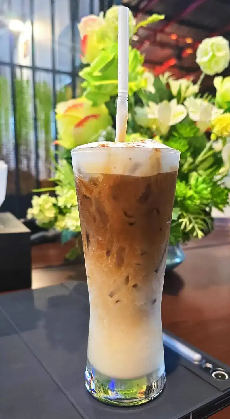 Iced coffee with milk in a tall glass
