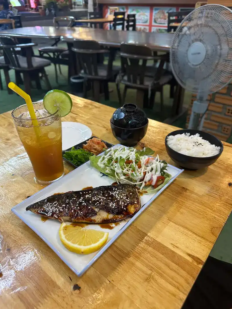 Grilled fish glazed in sauce, with rice, miso soup, salad and a cold drink