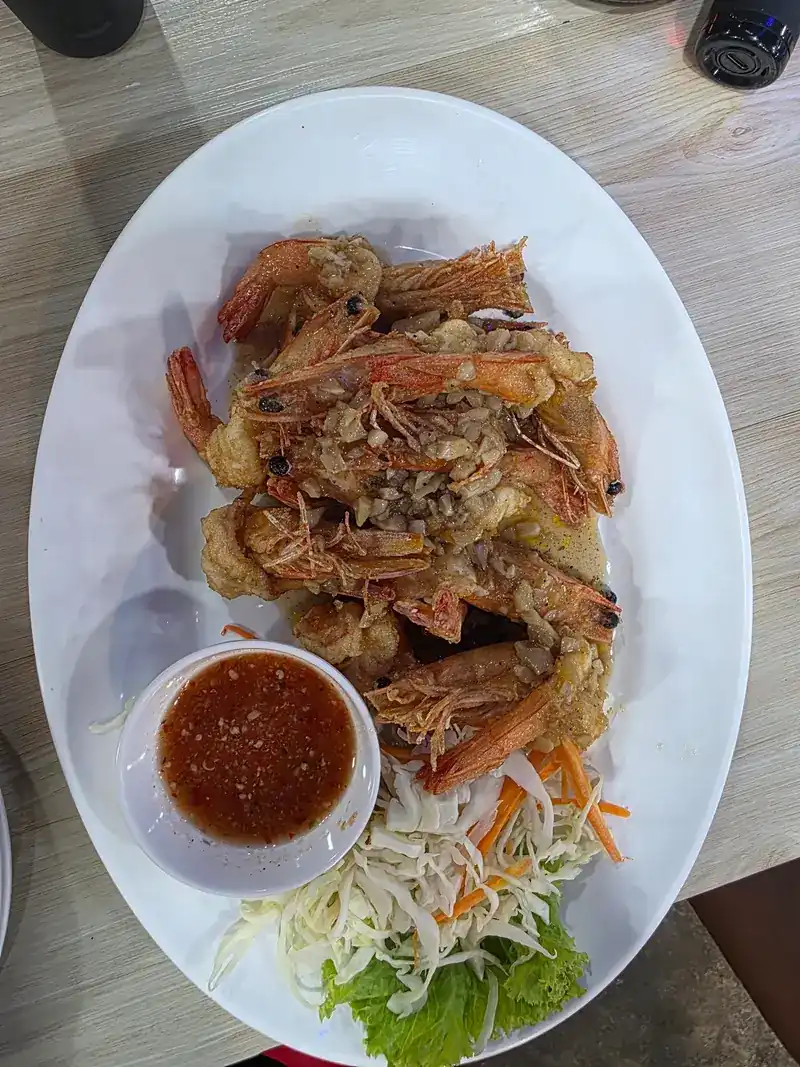 Fried prawns on an oval plate with dipping sauce