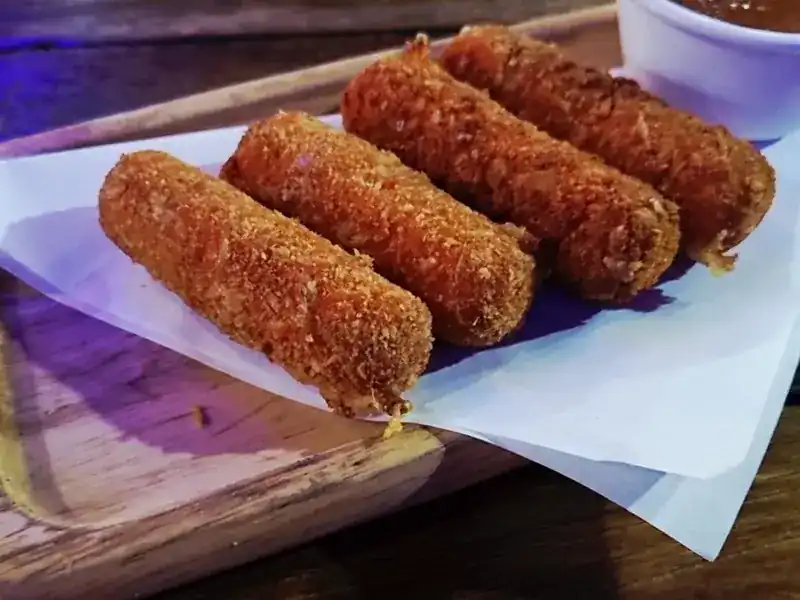 Four golden fried starters on paper