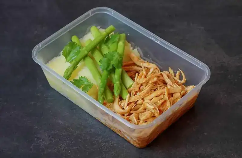 BBQ pulled chicken with mash, asparagus and coriander in a meal-prep box
