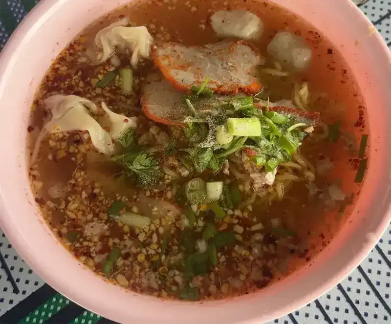 Tom yum egg noodles with wontons, red pork and meatballs