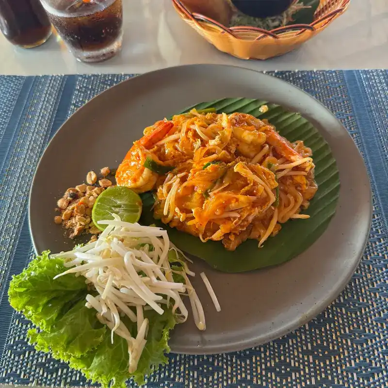 Pad thai with prawns on banana leaf, with bean sprouts, lime and crushed peanuts
