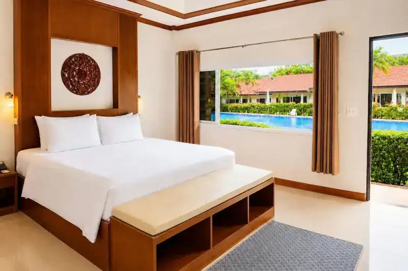 A double room with a window onto the pool