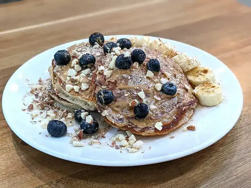 Pancakes with blueberries, banana and chopped nuts
