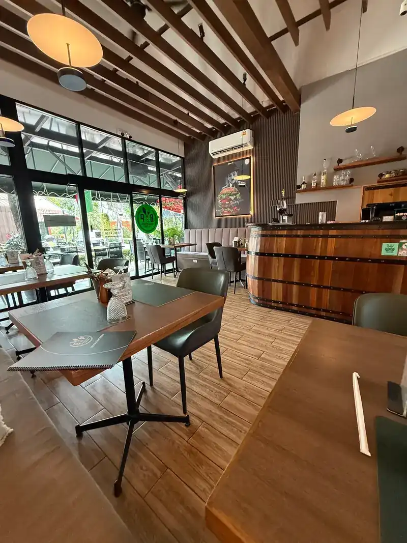 The dining room: wooden ceiling beams, big windows and the barrel bar