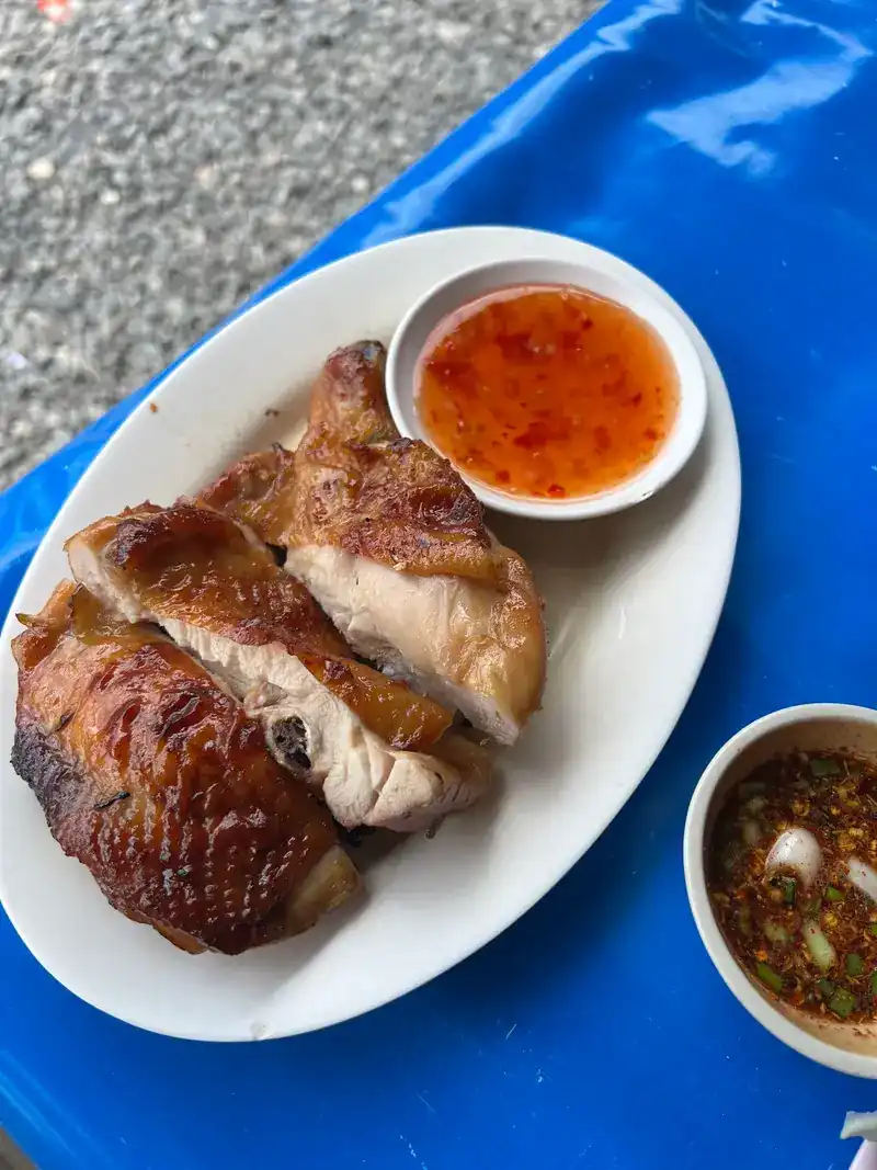 Grilled chicken with two dipping sauces on a blue tablecloth